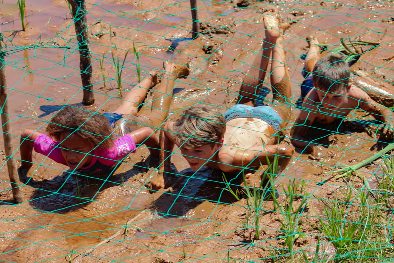 Youth Adventure Kids Camps children outdoor learning explore eswatini activities - adventure race mud crawl at dam